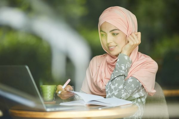 woman-in-hijab-watching-webinar.jpg